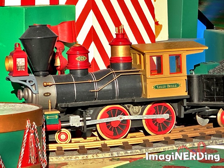 close-up of the lilly blue toy engine under the main street christmas tree at the magic kingdom